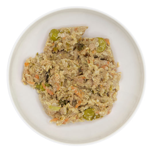 An image of The Nojo's Dog Pork recipe in a bowl. You can see the vibrant color of the cooked carrots, peas, quinoa, and pork.